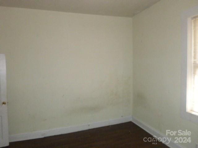 spare room with dark hardwood / wood-style flooring