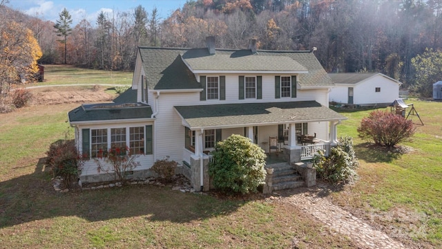 view of front facade featuring a front lawn and covered porch