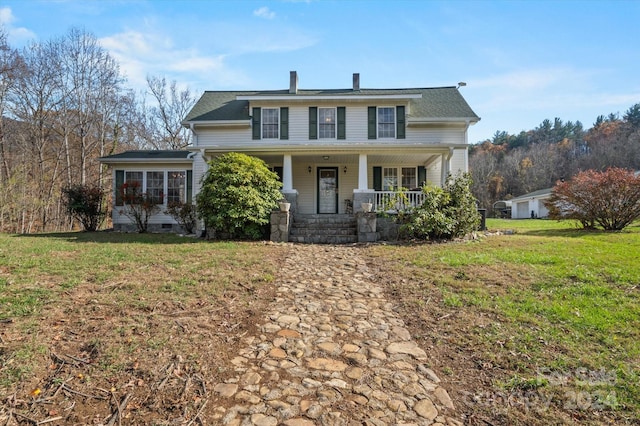 view of front of home featuring a front yard and a porch