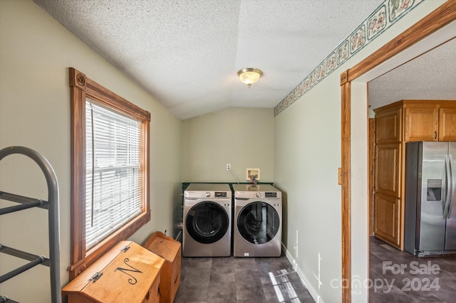 laundry area with cabinets, independent washer and dryer, and a textured ceiling