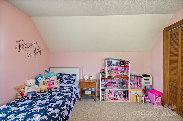 carpeted bedroom with a textured ceiling, a closet, and vaulted ceiling