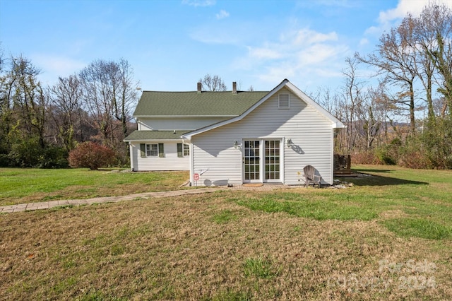 rear view of property featuring a yard