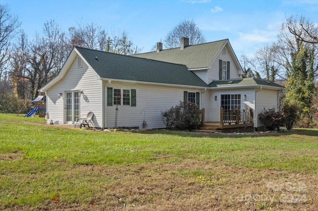 rear view of property with a lawn and a deck