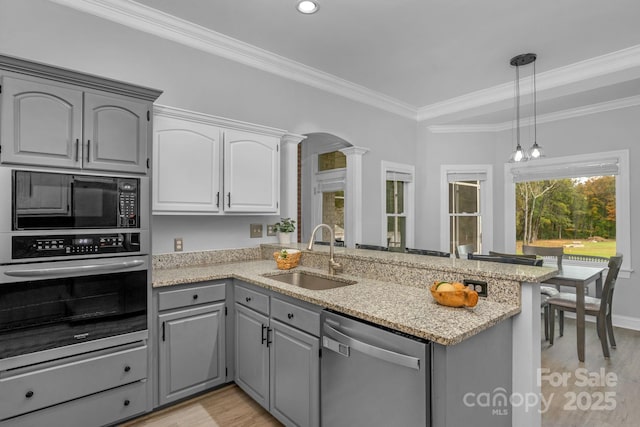 kitchen featuring sink, gray cabinets, appliances with stainless steel finishes, kitchen peninsula, and ornate columns