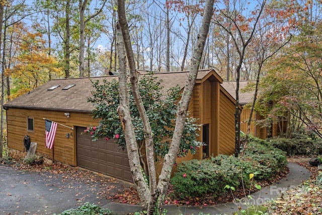 view of side of home featuring a garage