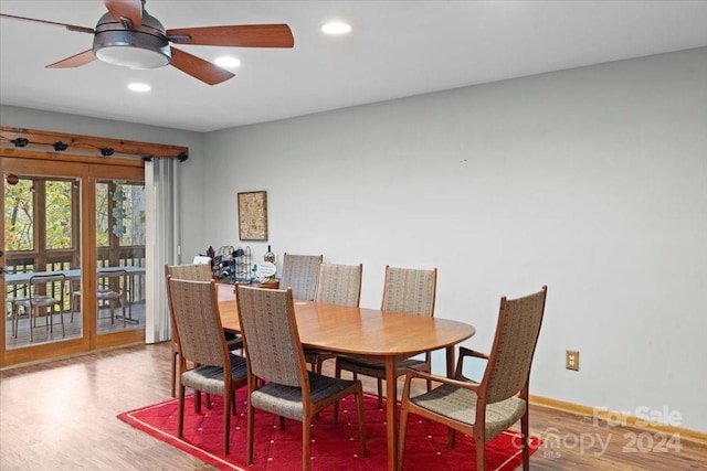 dining space with hardwood / wood-style floors and ceiling fan