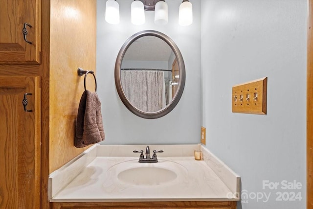 bathroom featuring vanity and curtained shower