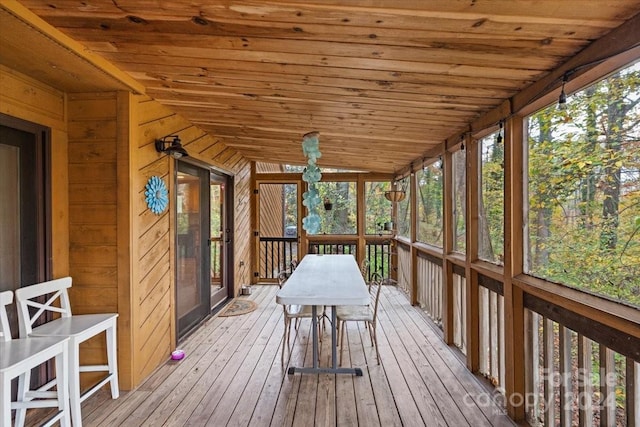 unfurnished sunroom featuring wooden ceiling and vaulted ceiling