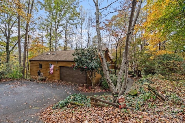 view of side of home featuring a garage