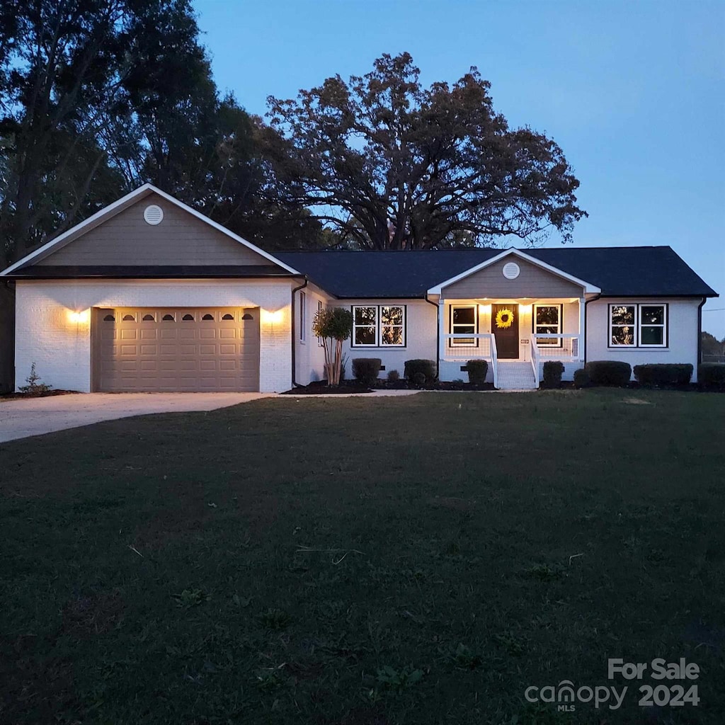 single story home with a yard and a garage