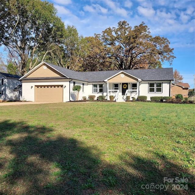 ranch-style house featuring a front lawn, a porch, and a garage