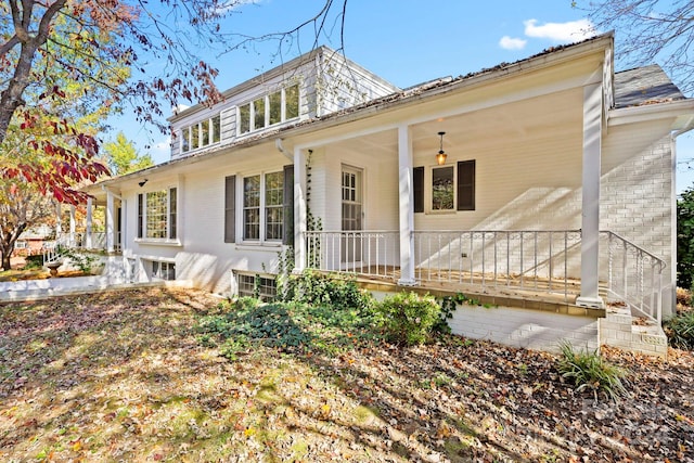 back of house featuring covered porch