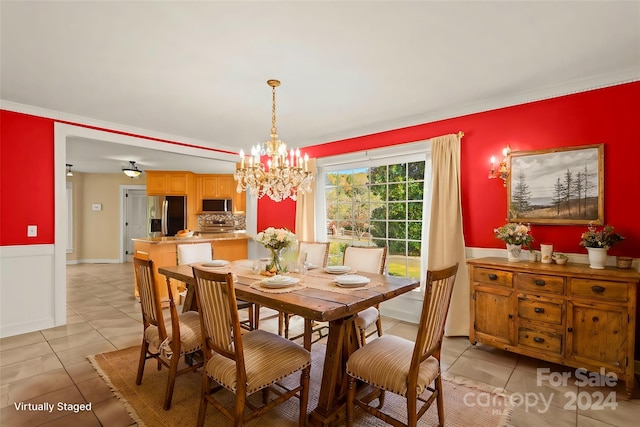 tiled dining space featuring a notable chandelier and ornamental molding