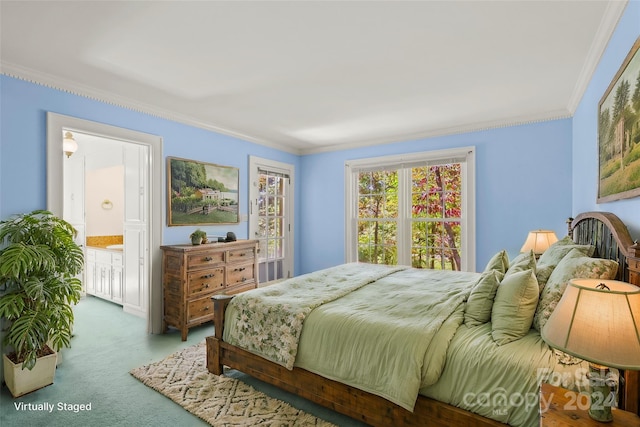 bedroom featuring ensuite bathroom, crown molding, and carpet floors