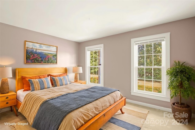 carpeted bedroom featuring multiple windows