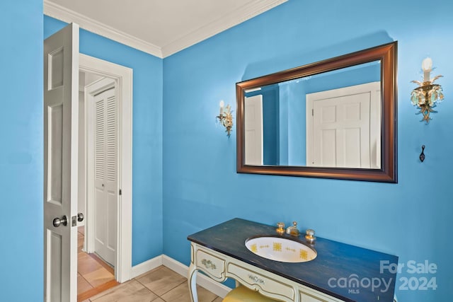 bathroom with vanity, crown molding, and tile patterned floors