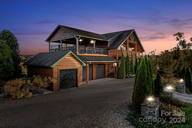 view of front of property featuring a garage and a balcony