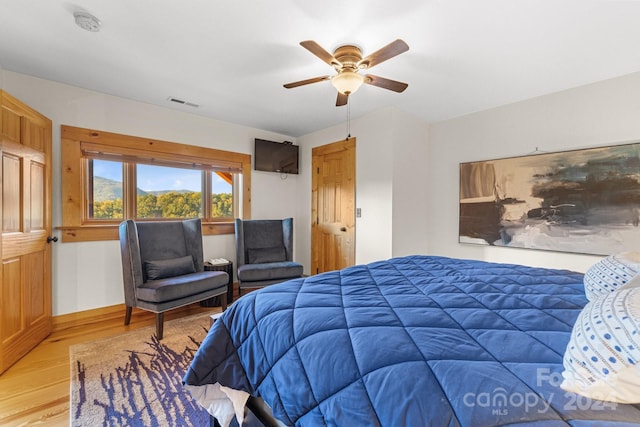 bedroom with hardwood / wood-style floors and ceiling fan