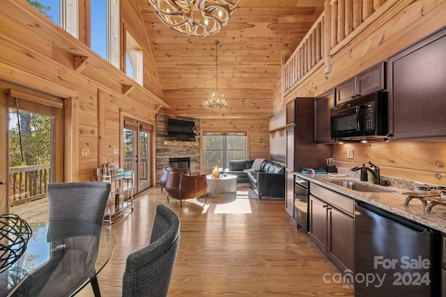 kitchen with dishwasher, light hardwood / wood-style flooring, sink, light stone countertops, and high vaulted ceiling