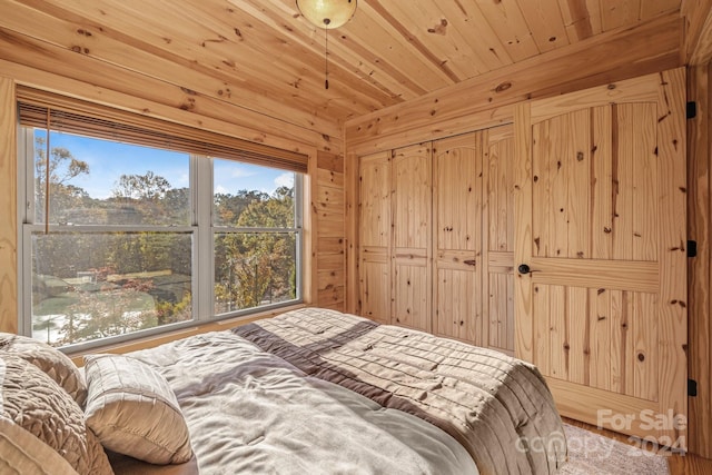 bedroom featuring wood ceiling and wooden walls