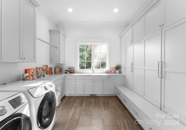 laundry room with ornamental molding, cabinets, dark hardwood / wood-style floors, and independent washer and dryer