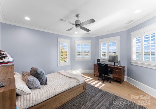 bedroom with multiple windows, ceiling fan, hardwood / wood-style floors, and crown molding