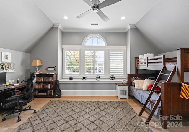 bedroom featuring light hardwood / wood-style flooring, ceiling fan, lofted ceiling, and crown molding