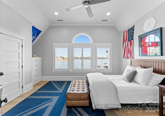 bedroom with hardwood / wood-style flooring, ceiling fan, crown molding, and vaulted ceiling