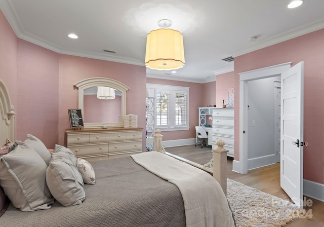 bedroom featuring light wood-type flooring and crown molding