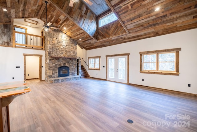 486 Hunter-Lysik Way, Laurel Springs, NC 28644 - unfurnished living room with ceiling fan, wooden ceiling with exposed beams, high vaulted ceiling, a fireplace, and plenty of natural light