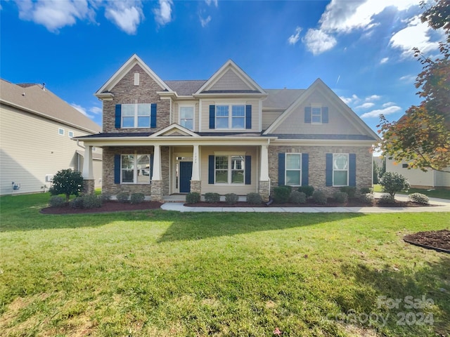 craftsman-style house with covered porch and a front lawn