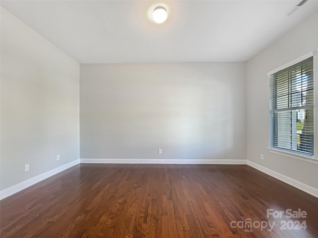 spare room featuring dark hardwood / wood-style flooring