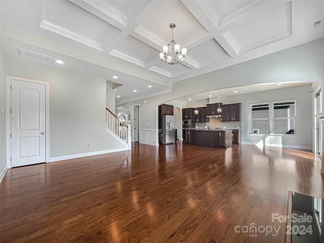 unfurnished living room with crown molding, beamed ceiling, coffered ceiling, and dark hardwood / wood-style flooring