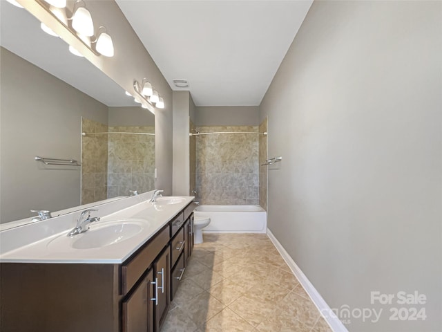 full bathroom with vanity, tiled shower / bath combo, toilet, and tile patterned floors