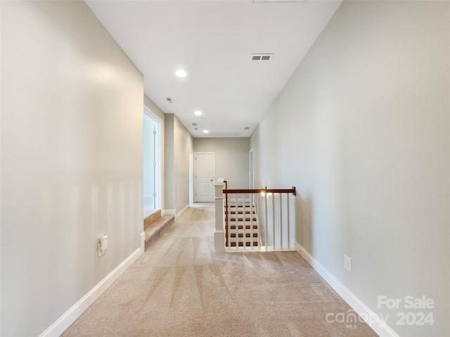 hallway featuring light carpet