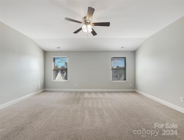 unfurnished room with ceiling fan, lofted ceiling, and light colored carpet