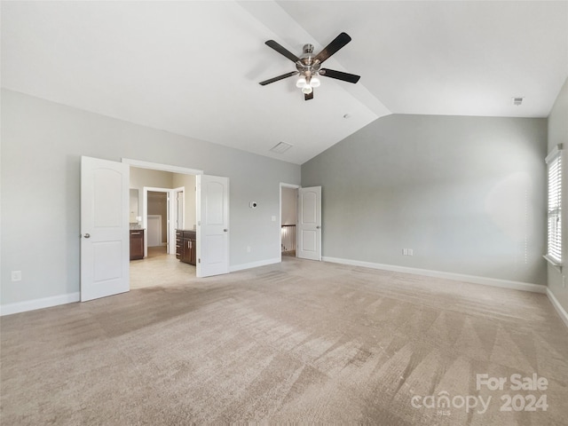 unfurnished living room with light carpet, vaulted ceiling, and ceiling fan