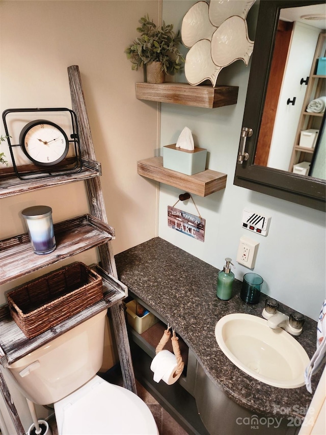 bathroom featuring toilet and sink