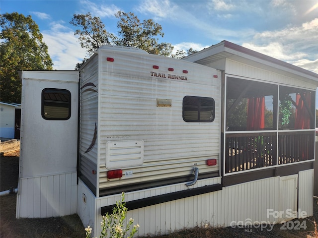 view of property exterior featuring a sunroom