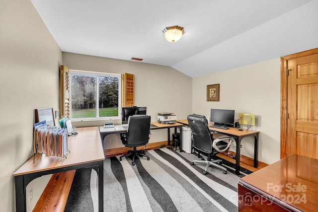 office space featuring carpet flooring and vaulted ceiling