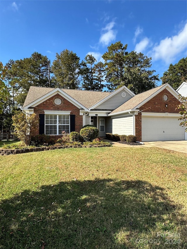 single story home with a front yard and a garage