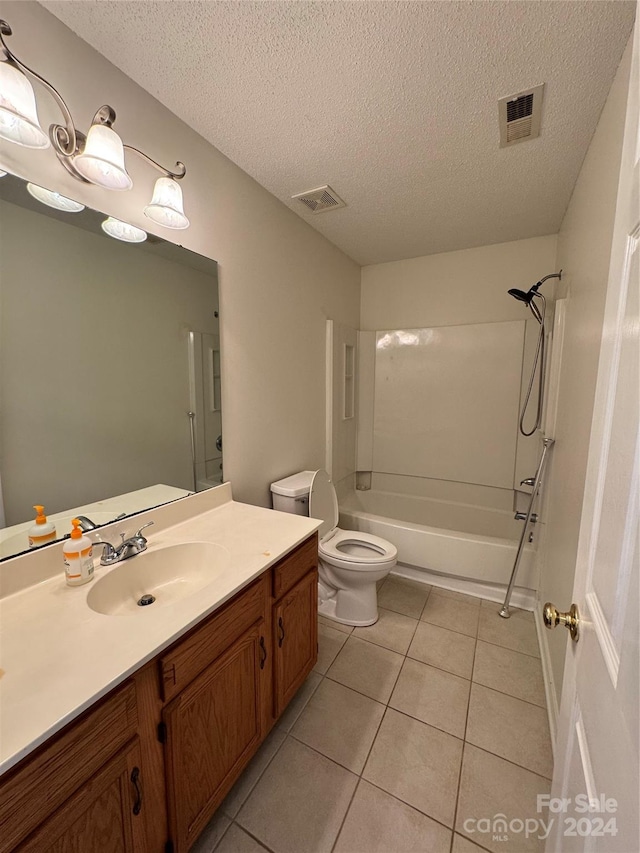 full bathroom with a textured ceiling, toilet, vanity, tile patterned floors, and washtub / shower combination