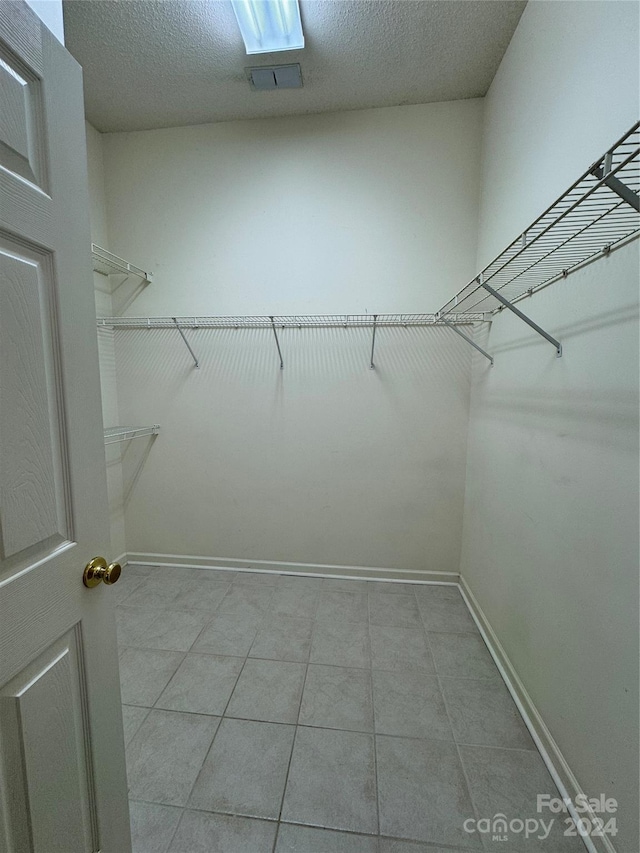 walk in closet featuring light tile patterned floors