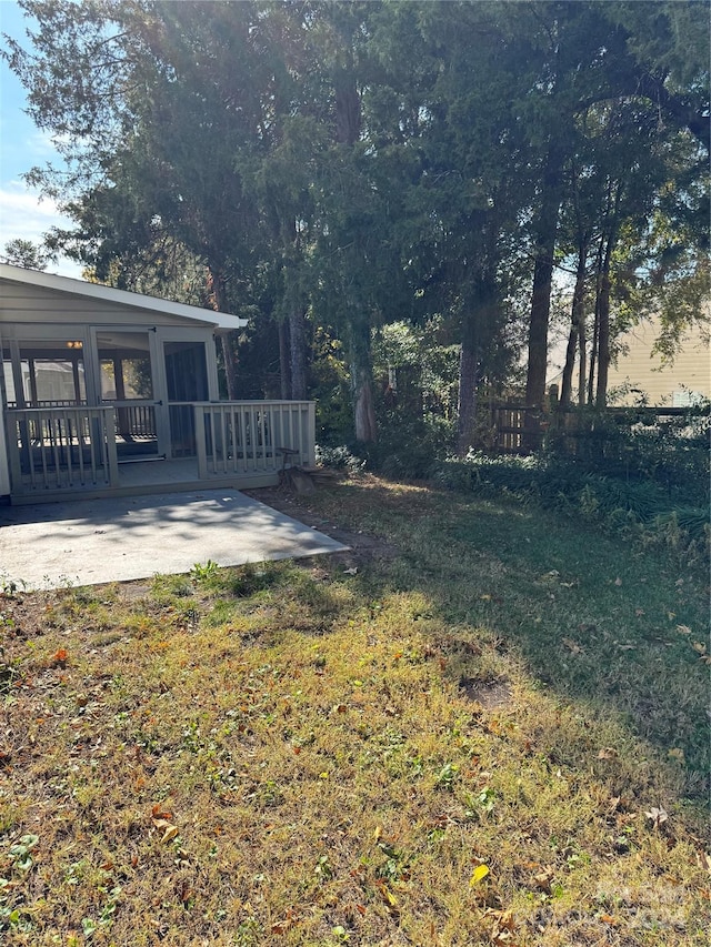 view of yard featuring a deck and a patio