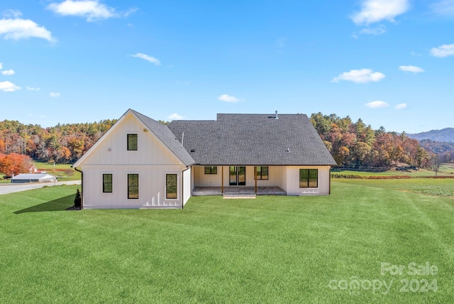 back of house with a yard and a patio area