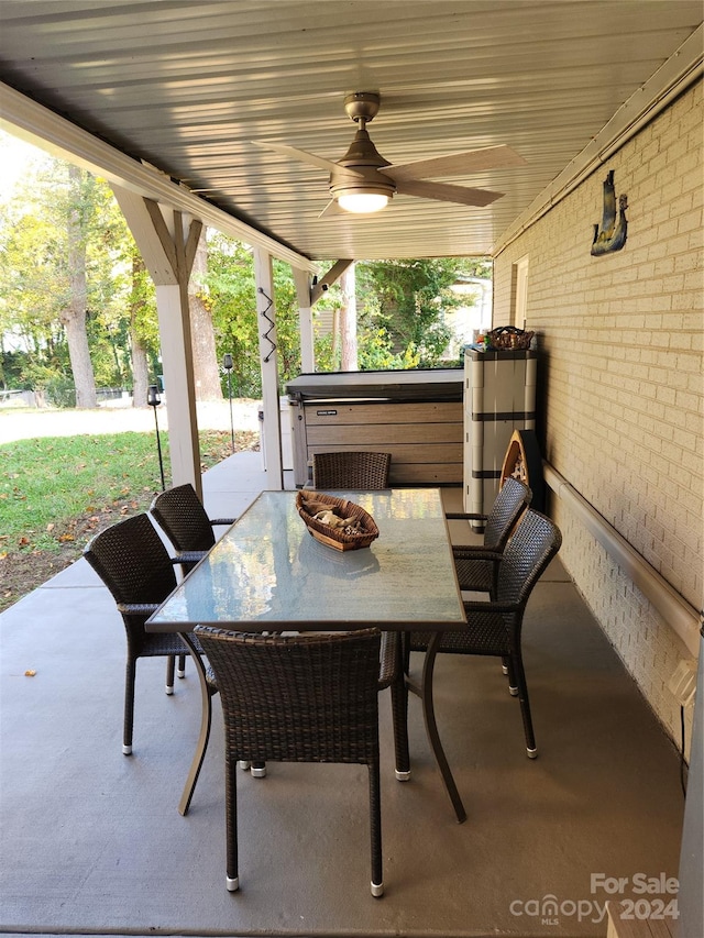 view of patio / terrace with ceiling fan and a hot tub