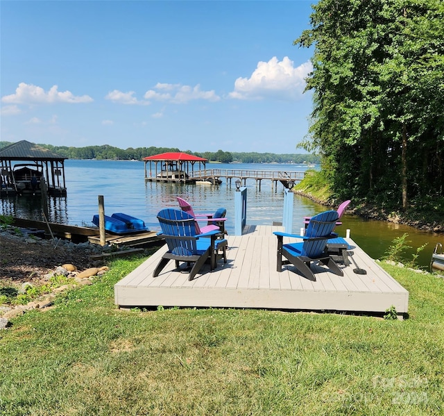 dock area featuring a lawn and a water view