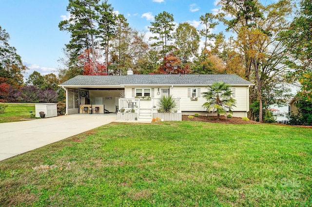 view of front of house featuring driveway, a shingled roof, a chimney, a carport, and a front yard