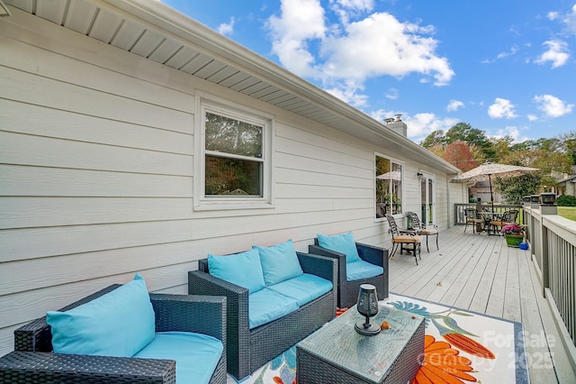 deck featuring outdoor lounge area and outdoor dining space