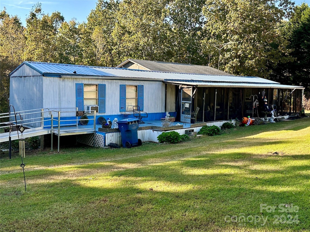 back of house with a lawn